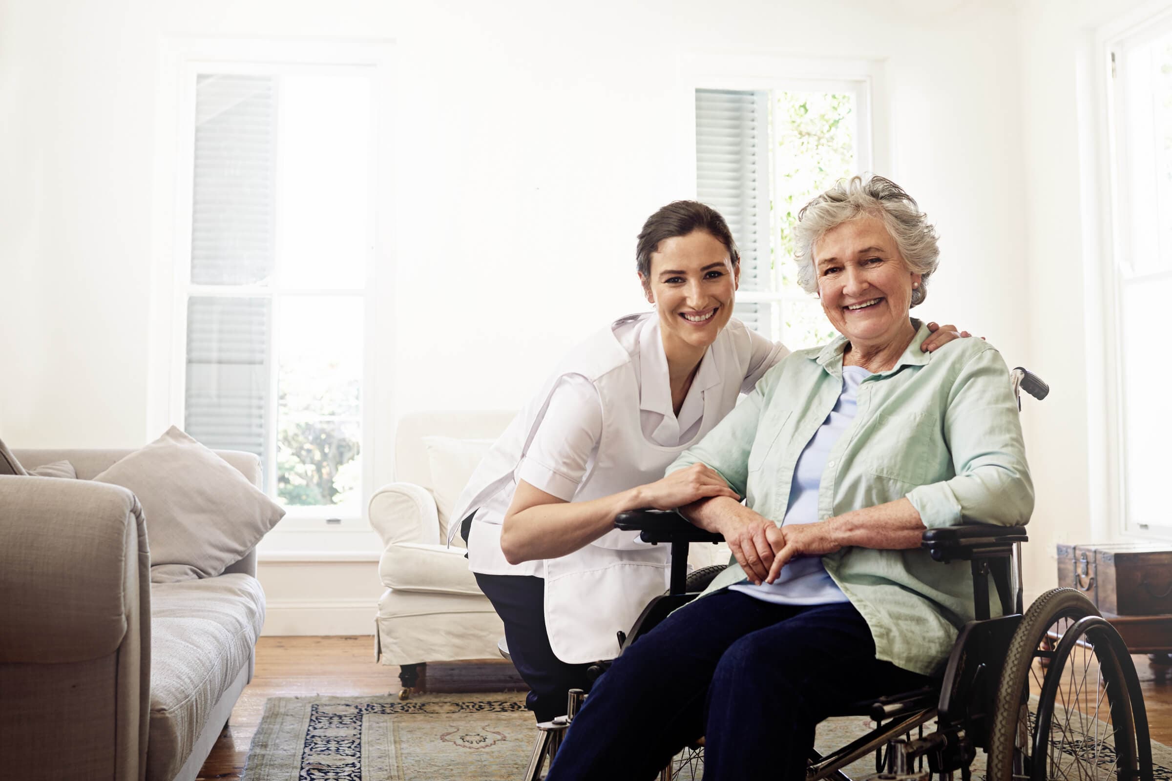 A caregiver sitting with an elderly patient
